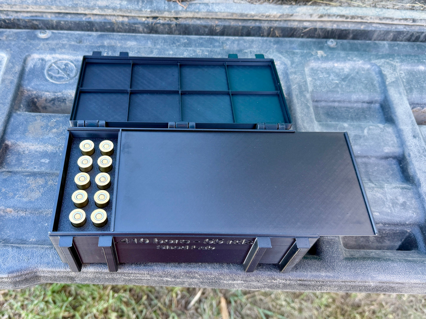 Inside view of 410 ammunition box showing upright shell storage slots